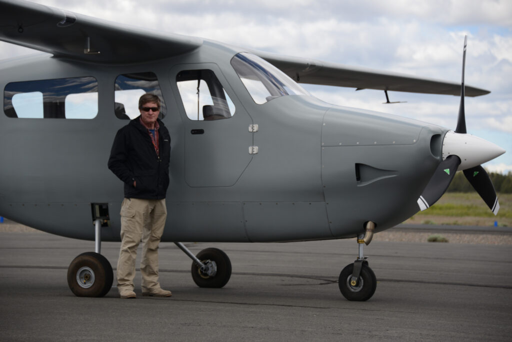 NightHawk QS3 on the ramp with a crew member standing beside the cabin