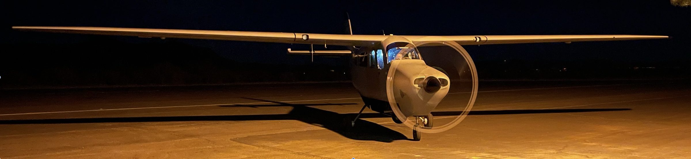 QS3 NightHawk aircraft on a dark runway with a circular LINEX flight-path overlay